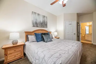 a bedroom with a large bed and a ceiling fan at Orlando Paradise: 3 Bed Condo6505 in Orlando
