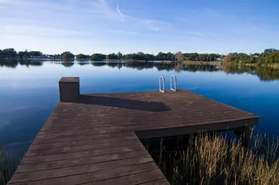 a dock on a lake with a view of the water at Lakefront and Pool 4bed Orlando House Near Downtown 20 minutes from Attractions in Orlando