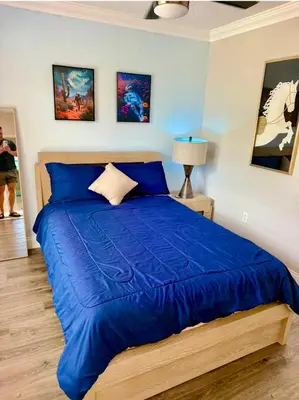 a bedroom with a large blue bed with blue sheets at Lakefront and Pool 4bed Orlando House Near Downtown 20 minutes from Attractions in Orlando