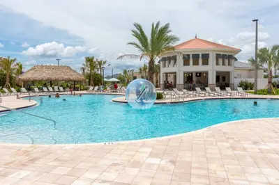 a pool at a resort with a ball in the middle at Brand New Luxury 2bd 2 bath Condo Home 270 in Kissimmee