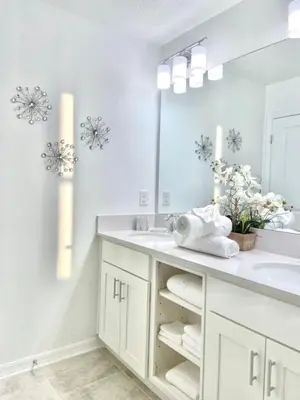a white bathroom with a sink and a mirror at Brand New Luxury 2bd 2 bath Condo Home 270 in Kissimmee