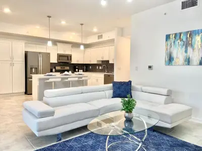 a living room with a white couch and a glass table at Brand New Luxury 2bd 2 bath Condo Home 270 in Kissimmee