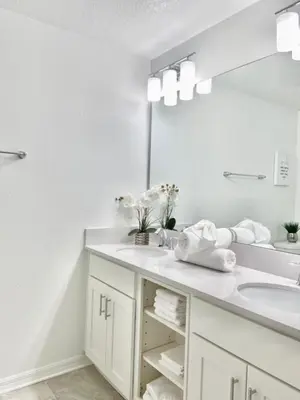 a white bathroom with a sink and a mirror at Brand New Luxury 2bd 2 bath Condo Home 270 in Kissimmee