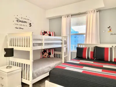 a white bedroom with two bunk beds and a bed at Brand New Luxury 2bd 2 bath Condo Home 270 in Kissimmee