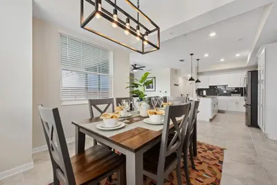 a dining room and kitchen with a table and chairs at Luxury 2bd 2 bath Condo Home 254 in Kissimmee