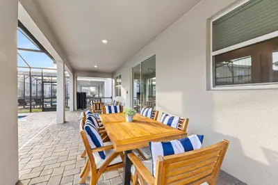 a dining room with a wooden table and chairs at 2869 Epic Themed Mega Home at Storey Lake 7DB in Kissimmee