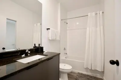 a white bathroom with a sink and a toilet at New great townhouse in The Hub in Kissimmee