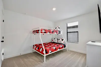 a bedroom with a bunk bed in a white room at New great townhouse in The Hub in Kissimmee