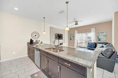 a kitchen with a sink and a counter top at Heated pool Lazy River Mini Golf Near Disney Resort in Kissimmee