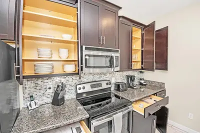 a kitchen with a stove and a microwave at Heated pool Lazy River Mini Golf Near Disney Resort in Kissimmee