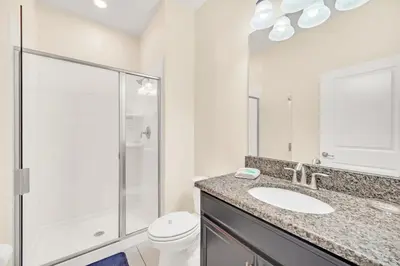 a bathroom with a shower and a sink and a toilet at Heated pool Lazy River Mini Golf Near Disney Resort in Kissimmee