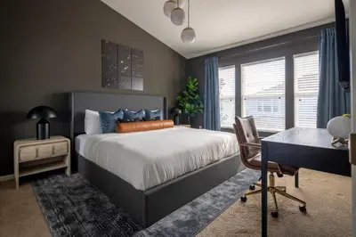 a bedroom with a bed and a desk and a window at Magical Getaway Close to Disney with Heated Pool in Orlando