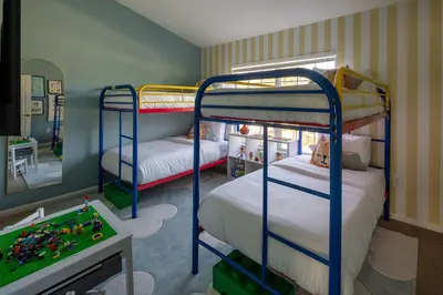 a bedroom with two bunk beds and a video game at Magical Getaway Close to Disney with Heated Pool in Orlando