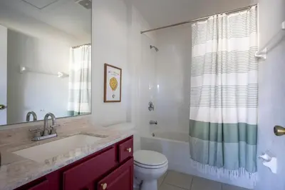 a bathroom with a sink and a toilet and a tub at Magical Getaway Close to Disney with Heated Pool in Orlando