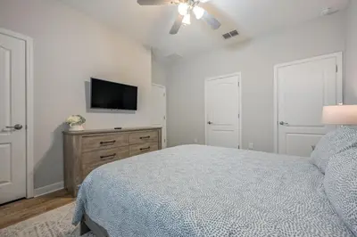 a bedroom with a bed and a flat screen tv at PP8962 - 4 Bedrooms w Pool & Resort Access in Kissimmee