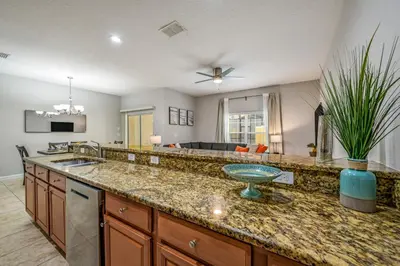 a kitchen with a sink and a counter top at PP8962 - 4 Bedrooms w Pool & Resort Access in Kissimmee