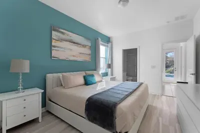 a bedroom with a bed with a blue wall at New Listing - Be the First Guest 5 BR - BV468 in Kissimmee