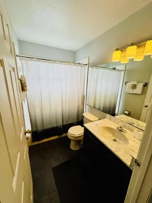 a bathroom with a sink and a toilet and a shower at Private Pool House With Lake View, Near All Famous Attractions!!! in Kissimmee
