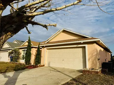 a house with a garage door in front of it at Private Pool House With Lake View, Near All Famous Attractions!!! in Kissimmee