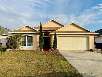 a house with a driveway and a garage at Private Pool House With Lake View, Near All Famous Attractions!!! in Kissimmee