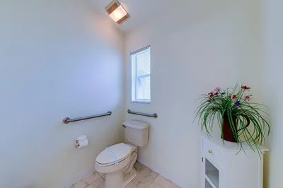 a bathroom with a toilet and a potted plant at 514 - Make Yourself at Home on our Private Pool Deck with Spa in Orlando