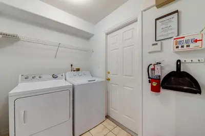 a white washer and dryer in a room at 514 - Make Yourself at Home on our Private Pool Deck with Spa in Orlando