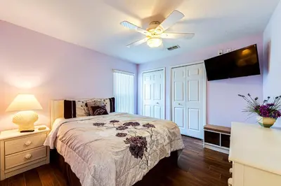 a bedroom with a bed and a ceiling fan at 514 - Make Yourself at Home on our Private Pool Deck with Spa in Orlando