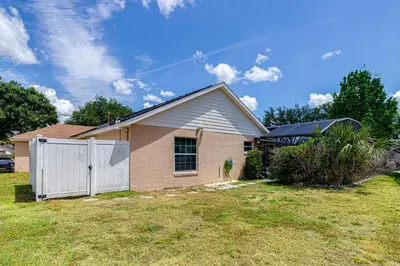 a house with a white fence in a yard at 514 - Make Yourself at Home on our Private Pool Deck with Spa in Orlando