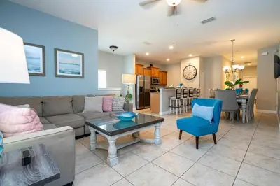 a living room with a couch and a table at Themed 5Bd Paradise Palms Close to Disney w Pool 8951 in Kissimmee