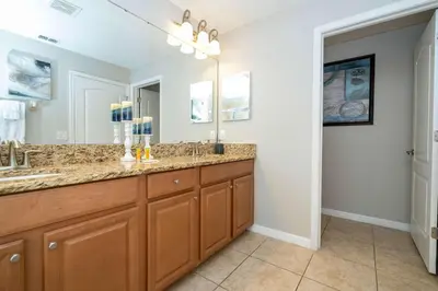 a bathroom with two sinks and a large mirror at Themed 5Bd Paradise Palms Close to Disney w Pool 8951 in Kissimmee