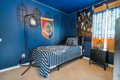 a bedroom with a bed in a blue room at Themed 5Bd Paradise Palms Close to Disney w Pool 8951 in Kissimmee