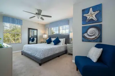 a blue bedroom with a bed and a blue chair at Themed 5Bd Paradise Palms Close to Disney w Pool 8951 in Kissimmee