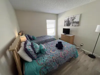 a bedroom with a bed and a television in it at Beautiful 4 Bed In Prime Location in Kissimmee