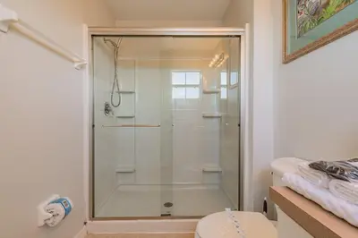a shower with a glass door in a bathroom at Charmosa 3Q/2.5B c/Jacuzzi * Vista Lago * in Kissimmee