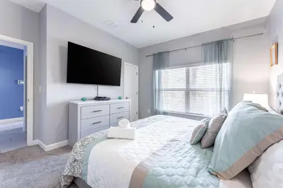a bedroom with a bed with a flat screen tv at Star Wars & Harry Potter Villa with Pool & Hot Tub in Kissimmee