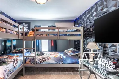a bedroom with two bunk beds and a desk at Star Wars & Harry Potter Villa with Pool & Hot Tub in Kissimmee