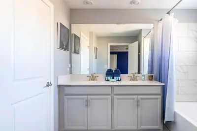a bathroom with two sinks and a large mirror at Star Wars & Harry Potter Villa with Pool & Hot Tub in Kissimmee