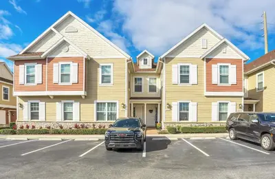 a car parked in a parking lot in front of a house at NEW amazing unique dream house 5 Min to Disney in Orlando