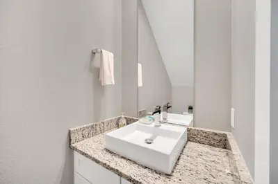 a bathroom with a white sink and a mirror at NEW amazing unique dream house 5 Min to Disney in Orlando