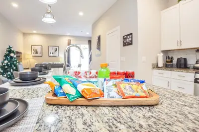 a kitchen counter with food on a cutting board at NEW amazing unique dream house 5 Min to Disney in Orlando