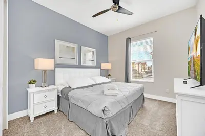 a bedroom with a bed and a ceiling fan at NEW amazing unique dream house 5 Min to Disney in Orlando
