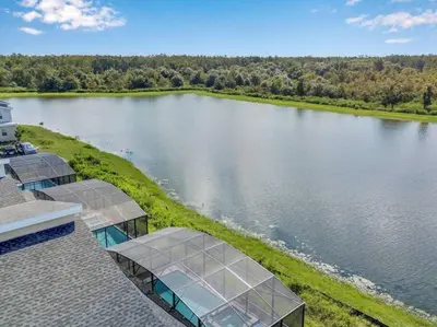 an aerial view of a lake with solar panels on a house at Top Luxury Villa Storey Lake mins to Disney in Kissimmee