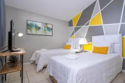 a bedroom with two beds and a television in it at Amazing 5 BR wgame room minutes from Disney in Kissimmee