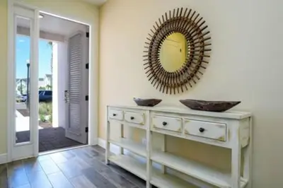 a bathroom with a vanity with a mirror on the wall at BRAND NEW Cozy 3BR Margaritaville in Orlando