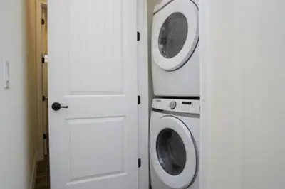 two washing machines and a washer and dryer in a room at BRAND NEW Cozy 3BR Margaritaville in Orlando