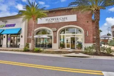 a building with a flower centre on the side of a street at BRAND NEW Cozy 3BR Margaritaville in Orlando