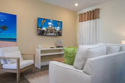 a living room with a white couch and a table at BRAND NEW Cozy 3BR Margaritaville in Orlando