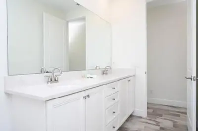 a white bathroom with two sinks and a large mirror at BRAND NEW Private Oasis 4 BR - Margaritaville in Orlando