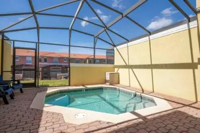a large swimming pool in a building with a roof at Cozy 3 BR wprivate pool in Kissimmee