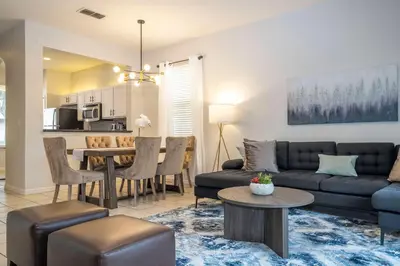 a living room with a couch and a table at Cozy 4BR Regal Oaks close to Disney in Orlando